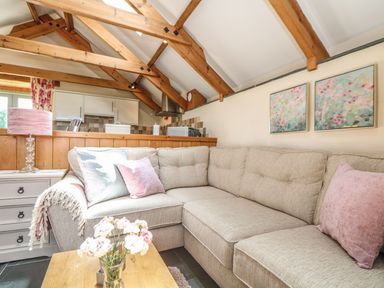 A living room with a sofa and a coffee table at Oak Cottage in Truro