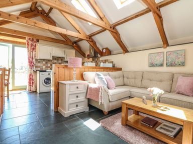 A living room with a sofa and coffee table at Oak Cottage in Truro