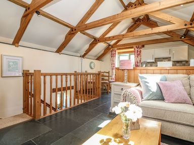A living room with a sofa and coffee table at Oak Cottage in Truro