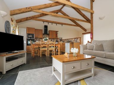A living room with a sofa and coffee table at Hawthorn Cottage in Truro