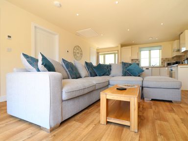 A living room with a sofa and coffee table at Elm Cottage in Truro