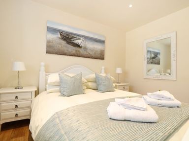 A bedroom with a bed and bedside tables at Elm Cottage in Truro