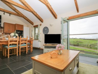 A kitchen with a table and chairs at Ash Cottage in Truro
