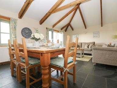 A dining area with a table and chairs at Ash Cottage in Truro
