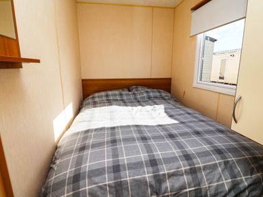 A bedroom with a bed and window at Beach Fields 45 in Kinmel Bay