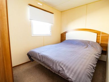 A bedroom with a bed and a window at Beach Fields 45 in Kinmel Bay