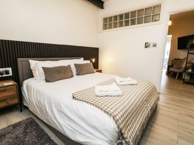 A bedroom with a bed and bedside table at Flat 1, 2 Wooperton Street Weymouth