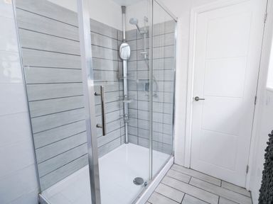 A bathroom with a glass shower enclosure at Flat 1, 2 Wooperton Street Weymouth