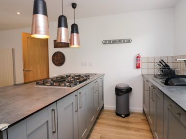 A kitchen with a cooker and cabinets at 10 Rayrigg Rise Bowness-On-Windermere