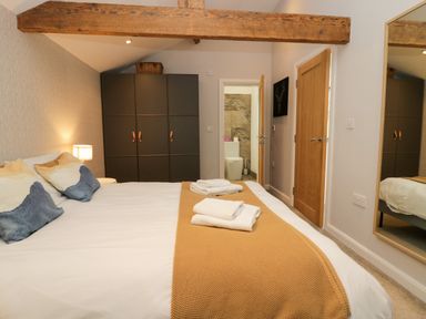 A bedroom featuring a bed with pillows and a wardrobe at 10 Rayrigg Rise Bowness-On-Windermere