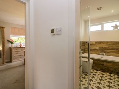 A bathroom featuring a bath, toilet, and sink at 10 Rayrigg Rise in Bowness-On-Windermere