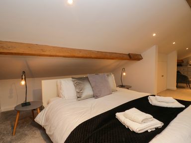 A bedroom with a bed and bedside table at 10 Rayrigg Rise Bowness-On-Windermere