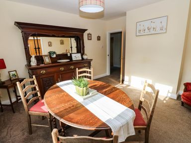 A dining room with a table and chairs at The Bungalow in Penrith