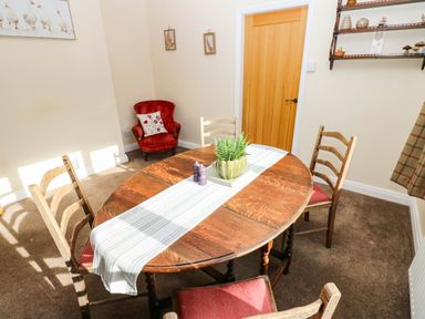 A dining room with a table and chairs at The Bungalow in Penrith