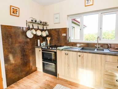 A kitchen with an oven and sink at The Bungalow in Penrith