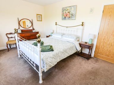 A bedroom with a bed and furniture at The Bungalow in Penrith