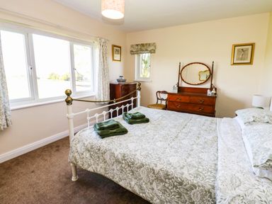 A bedroom with a bed and dressing table at The Bungalow in Penrith