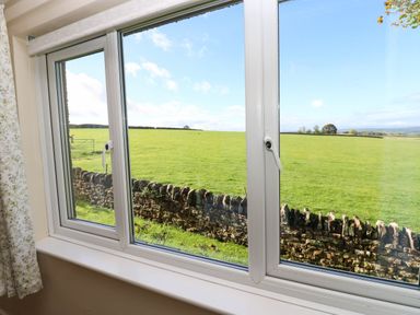 A view of a field through a window at The Bungalow in Penrith