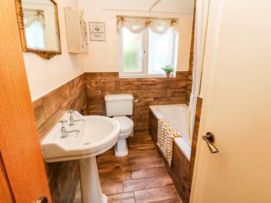 A bathroom with a sink, toilet and bathtub at The Bungalow in Penrith
