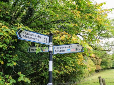 A signpost with directions to various locations at The Bungalow in Penrith