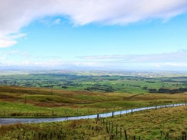 A view of hills and fields from a road at The Bungalow in Penrith