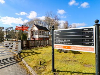 An outdoor area with a signal box and a signpost at The Bungalow in Penrith