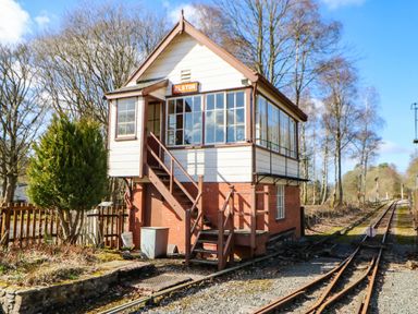 A signal box with railway tracks and trees at The Bungalow in Penrith