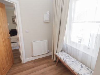 A hallway with a bench and a radiator at Flat 3 in Tenby