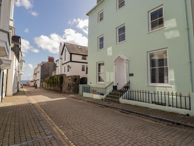 A street with buildings and a view of the sea at Flat 3 in Tenby
