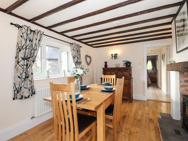 A dining room with a table and chairs at High Beck Cottage in Kendal