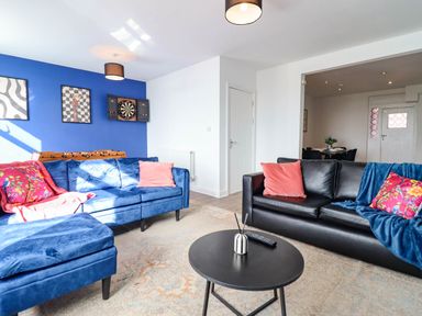 A living room with a sofa and coffee table at Flat 4 Greenfields Barmouth