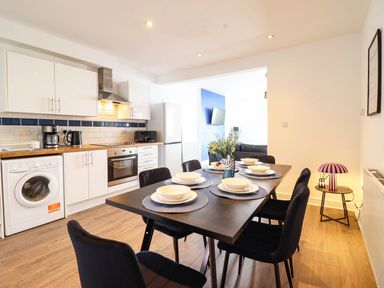 A kitchen with table and chairs at Flat 4 Greenfields Barmouth