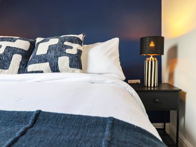 A bedroom with a bed and lamp at Flat 4 Greenfields Barmouth