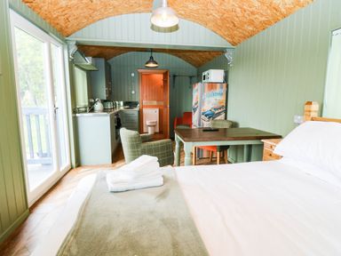 A studio with kitchen area and dining table at Calendonia Hut West Mains near Haggerston