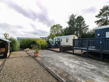 An outdoor area with cabins and plants at Calendonia Hut in West Mains near Haggerston