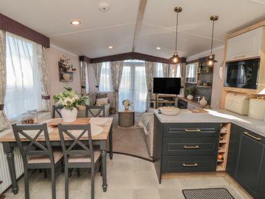 A kitchen with a dining table and sofa at 19 Finch