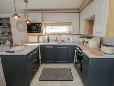 A kitchen with cabinets, sink, stove, and appliances at 19 Finch in 