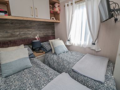 A bedroom with two beds and a window at 19 Finch