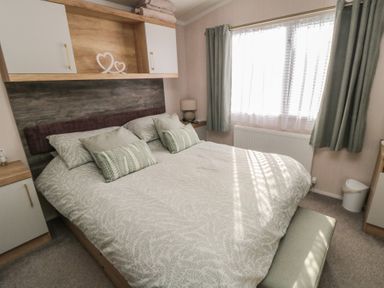 A bedroom with a double bed and a window at 19 Finch