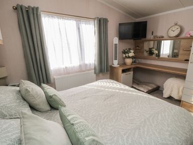 A bedroom with a bed and desk at 19 Finch