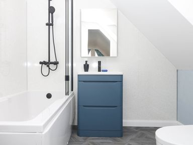 A bathroom with a bathtub and sink at Merlins Hideaway in Dawlish
