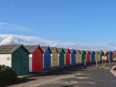 A row of colorful beach huts at Merlins Hideaway in Dawlish