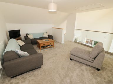 A living room with a sofa and coffee table at Cae Mawr in Caernarfon