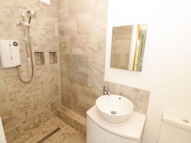 A bathroom with shower and sink at Cae Mawr in Caernarfon