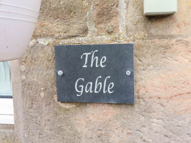A nameplate on a stone wall at The Gables in Alnwick