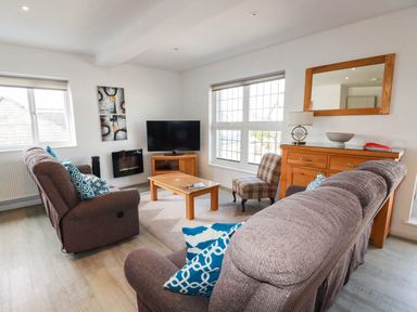 A living room with a sofa and television at Apartment 3 in Newquay