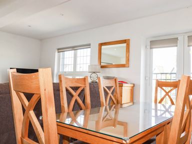 A dining area with a table and chairs at Apartment 3 in Newquay