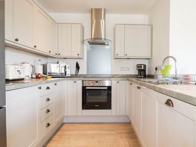 A kitchen with cabinets and appliances at Apartment 3 in Newquay