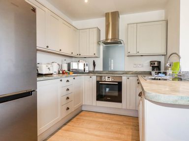 A kitchen with appliances and cabinetry at Apartment 3 in Newquay