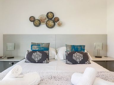 A bedroom with a bed and decorative pillows at Apartment 3 in Newquay